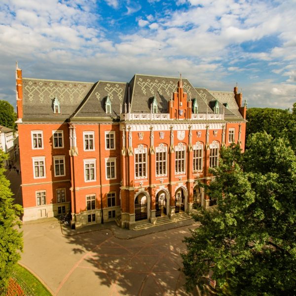 a large brick building with trees in the background